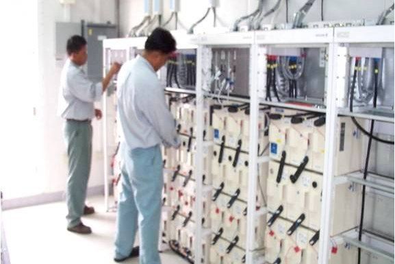 Engineers installing a DC power plant